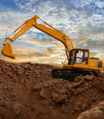 Excavators are digging the soil in the construction site on the sky and cloud background,With lift up bucket.